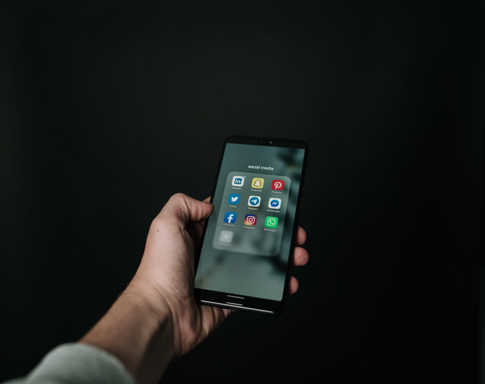 pexels-magnus-mueller-2818118 A man holding the mobile phone inside of social media apps
